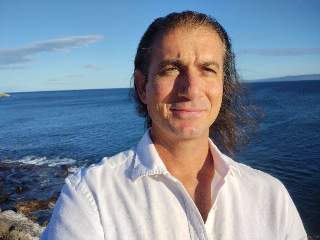 Ugo Tsalapatanis, hypnotherapist, by the ocean on Maui